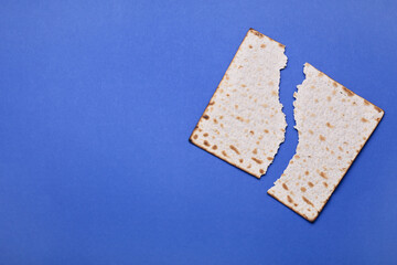 Jewish flatbread matzo for Passover on blue background
