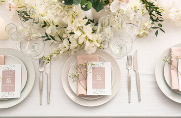Stylish table setting with wedding invitations and gypsophila flowers, top view - Powered by Adobe