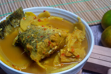 Southern Thai Gaeng Som - Sour white snapper fish soup with bamboo shoots, spicy flavor.