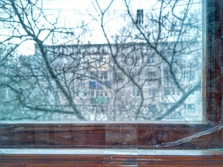 window sealed with tape because of the war in Ukraine. The safety of people in the apartment during hostilities