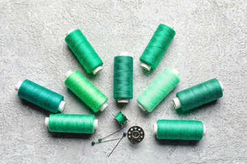 Green sewing threads on light background