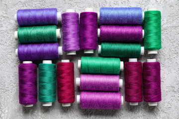 Different sewing threads on light background