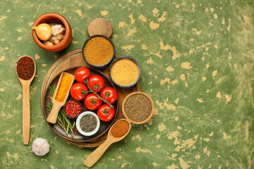 Fototapeta na wymiar Composition with aromatic spices and fresh vegetables on color background