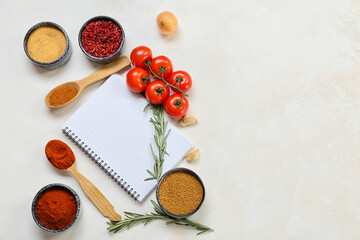 Fototapeta na wymiar Composition with blank notebook, vegetables and spices on light background