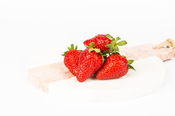 strawberries in bowl on marble on white background