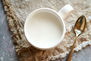Obraz na płótnie Canvas Milk kefir in a white cup on a table
