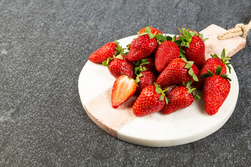 strawberries on black background on marble