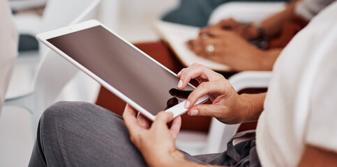 Are you keeping up with the technological evolution. Closeup shot of an unrecognisable businesswoman using a digital tablet in an office.