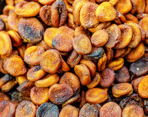 Brown dried apricots. Sale of dried fruits. Dietary food. The concept of healthy eating.
