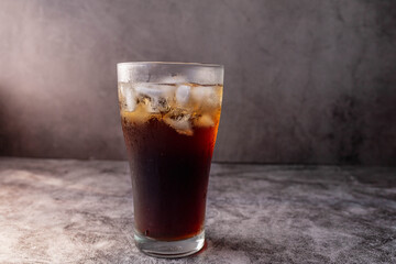 cola drink in a glass with ice