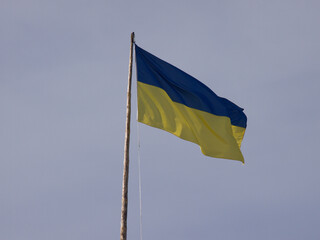 Ukrainian flag waving against dark blue sky landscape