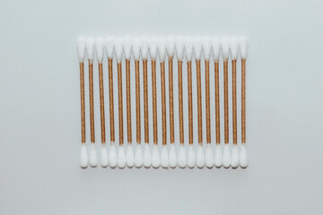 Eco-friendly bamboo cosmetic cotton buds on a light background.