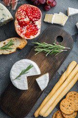 French soft camembert of normandy cheese, on gray background, top view