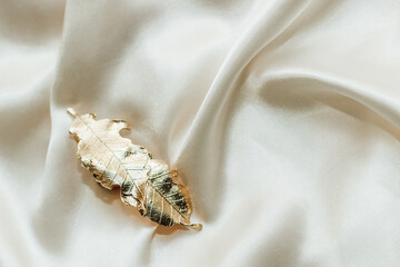 Golden hairpins on golden silk background, social media content..