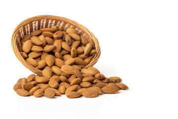 Almond. Overturned basket with almonds isolated on white background.