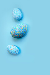 Blue Easter decorative eggs on a pastel background.