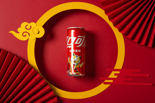 ZHONGSHAN China-February 18,2022:can of original flavor Coca-Cola specially for 2022 Chinese New Year of Tiger with Chinese style decorations.