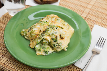 wholesome breakfast. omelet with broccoli on green plate