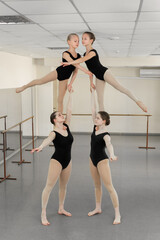 Young ballerinas rehearse a choreographic exercise at a ballet school
