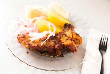 dish of fried pork ribs, rice, potatoes, sweet potato and pickled onions