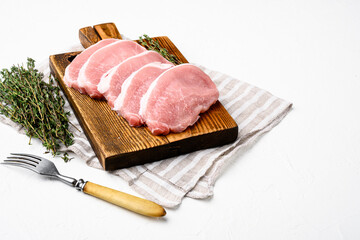 Pork meat. Fresh pork steaks, on white stone table background, with copy space for text