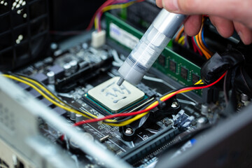 Naklejka premium Thermal paste is applied to the laptop processor