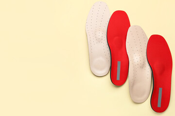 Different orthopedic insoles on color background