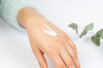 woman hand taking cream on white background