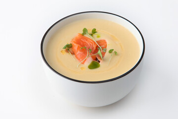 Cream soup of leeks, potatoes and cream. Cream soup Vichy with salmon in a white plate. Healthy food. Healthy lifestyle.Lean menu. Isolated object. White background.Copy space.