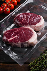 Beef steak pack, on old dark  wooden table background