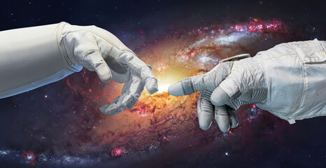 Astronaut in glove and robot hands in space. Spiral galaxy on background. Technology and space flight. Elements of this image furnished by NASA