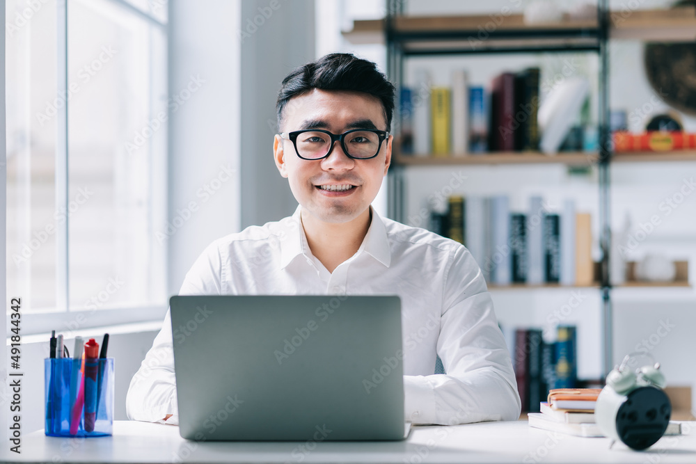 Wall mural young asian businessman working at office