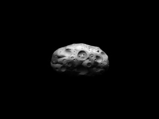 Asteroid covered with impact craters on a black background. Large meteorite isolated. Surface of the space stone. 
