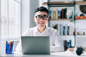 Young Asian businessman working at office