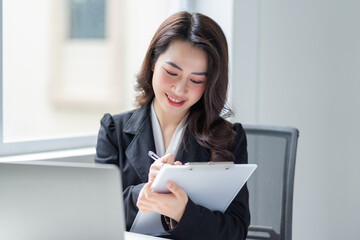 Image of young Asian businesswoman working at office