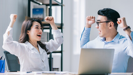 Two Asian businesspeople working at office