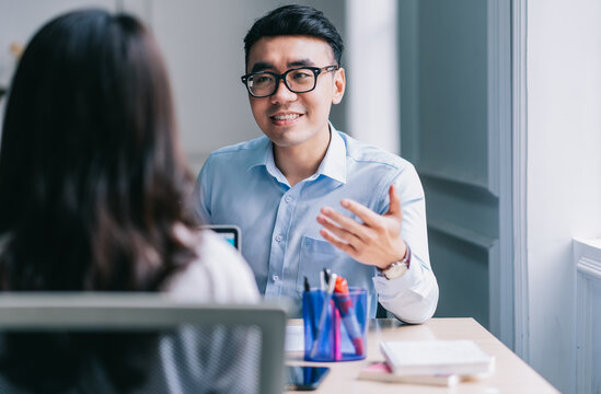 Two Asian businesspeople working at office