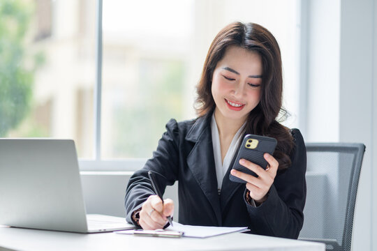 Image of young Asian businesswoman working at office