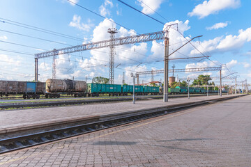 Fototapeta premium Krivoy Rog railway station. Trains. Ukrainian railway. Beautiful clouds over the city. Trips.