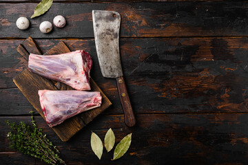 Uncooked lamb shank, on old dark  wooden table background, top view flat lay, with copy space for...