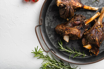 Lamb shanks cooked in a rich gravy, on white stone table background, top view flat lay, with copy...