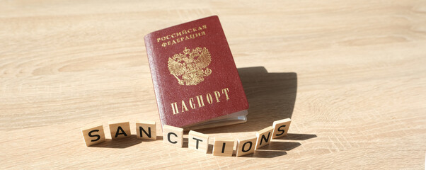 passport of citizen Russian Federation, word sanctions on wooden letters, concept of economic...