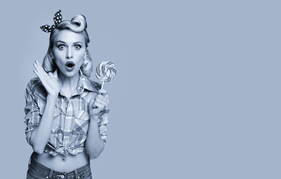 Woman with lollipop in pinup style. Blond girl posing in retro fashion and vintage concept. Black and white. Copy space.