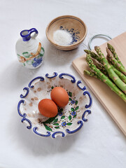 A healthy and tasty breakfast idea. Asparagus and eggs with a pinch of salt and oil ready to be cooked
