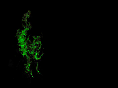 Green flames of toxic love. The dancing flames of the fire. Intensive green. To be used as a background with place for text. High color saturation.