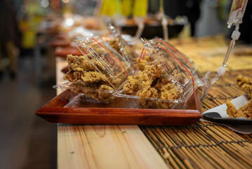 Karaage or Japanese-style fried chicken is packed in a plastic container and for sale - Japanese street food. 
