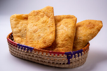 Brazilian pastries in a basket over white background.