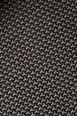 Knitted texture. Texture of jacquard fabric with gray geometric pattern. Crochet mosaic pattern.