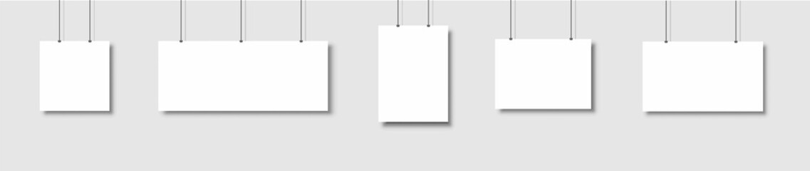 Template of white blank vector posters. Set of mockups hanging on the wall. Frame for paper sheet. Isolated on gray background. Vector illustration