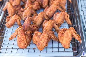chef cooking crispy fried chicken in oil hot pan on street food market in Thailand. Delicious homemade crispy fried chicken. Crunchy Fried Chicken Ready To Eat